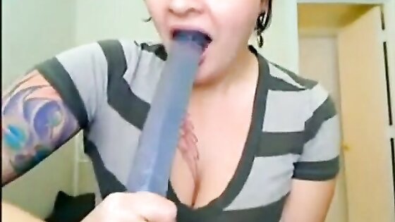 big titted, tattooed babe throatfucks herself