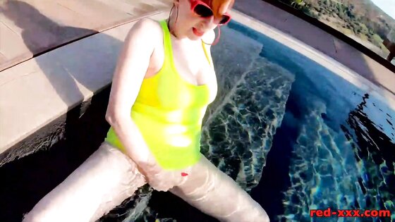 Red XXX fucks her pussy with a toy in the pool