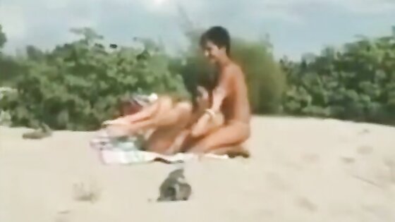 Two lesbians finger and lick each other on the beach