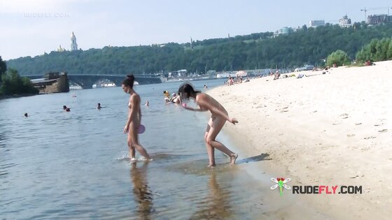 Bombastic young nudist babes sunbathe nude at the beach