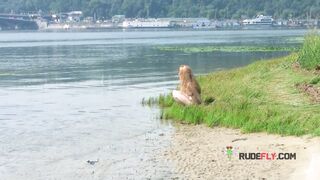 Playful blond nudist teen caught on camera naked at the beach