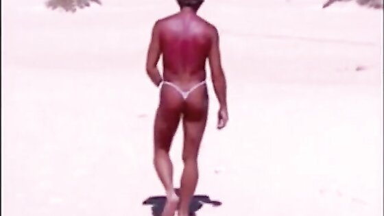 Tanned guy on beach in tiny string thong (temporarily!)