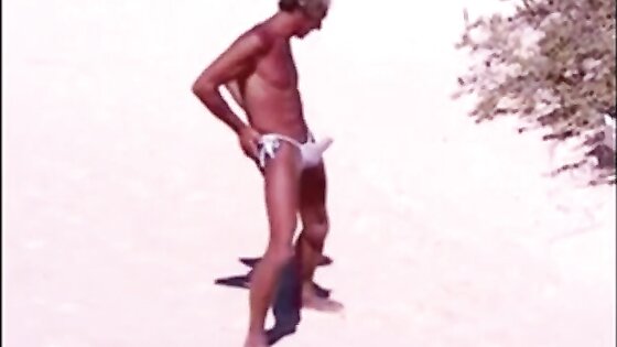 Tanned guy on beach in tiny string thong (temporarily!)