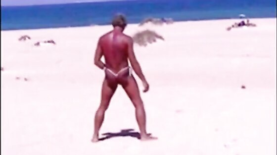 Tanned guy on beach in tiny string thong (temporarily!)