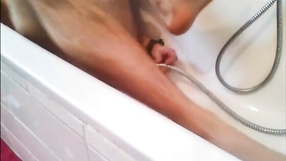 Bi-guy using shower head, squirting water, enema