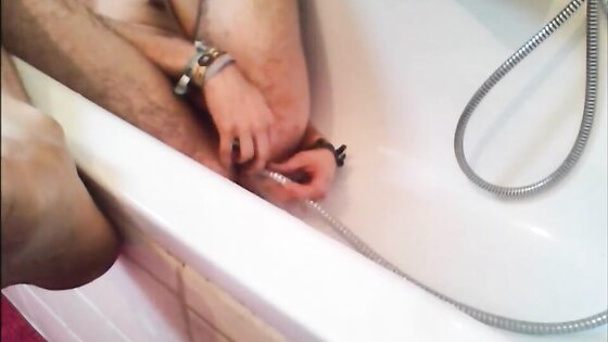 Bi-guy using shower head, squirting water, enema