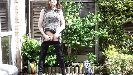 Sexy masturbating crossdresser in thigh boots outdoors