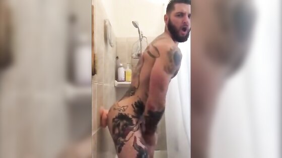 Tatted Hunk Fucks Dildo in Shower Until He Cums